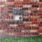 ENER-J IP65 waterproof outdoor socket mounted on brick wall during heavy rain