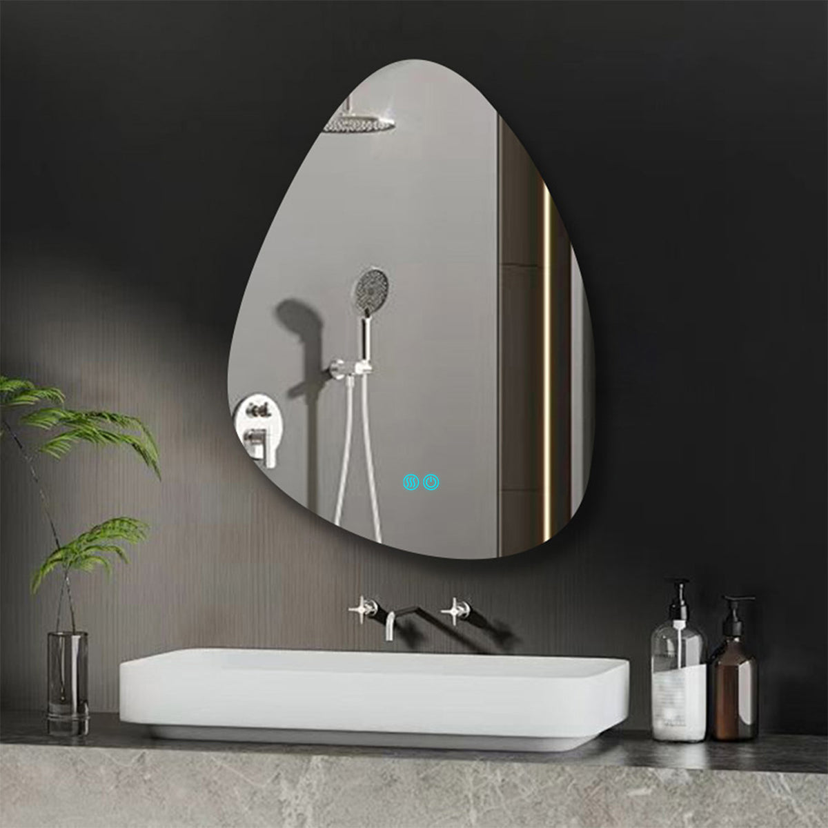 A teardrop-shaped wall mirror with an integrated LED light strip and touch controls, mounted on a dark gray bathroom wall above a white vessel sink.
